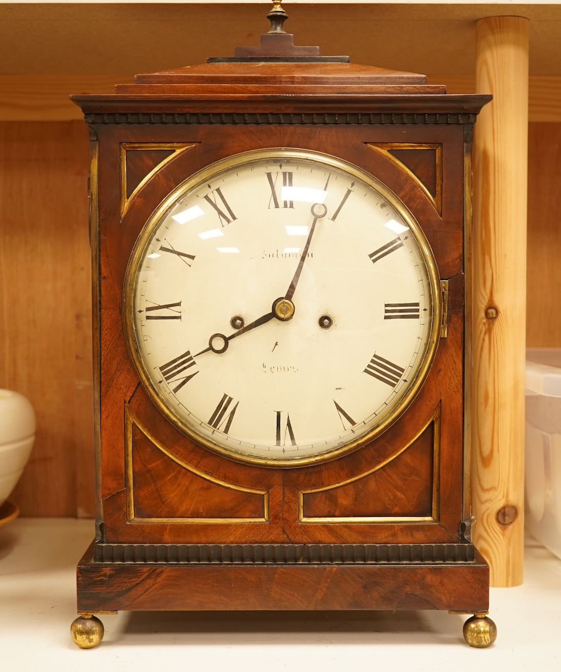 An early 19th century rosewood and brass bracket clock, striking on a bell, with pendulum and key, 47cm high